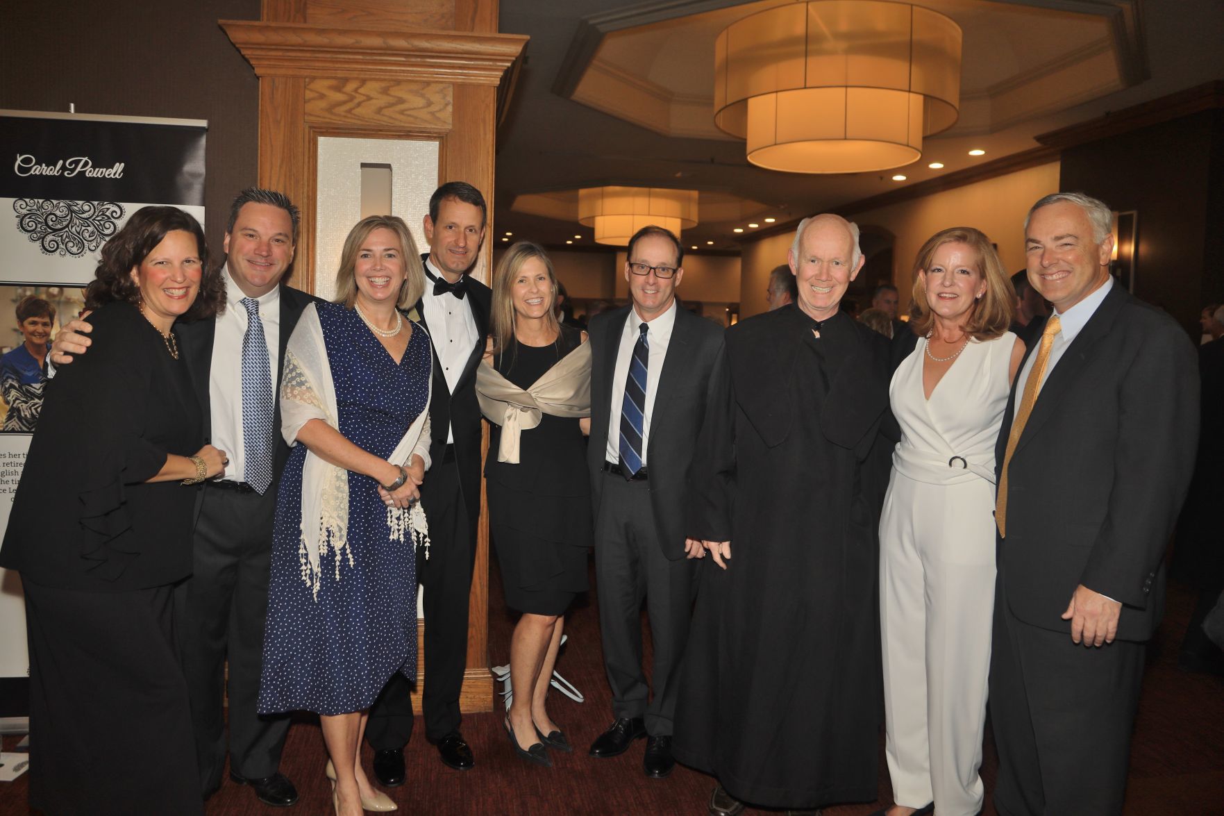 Kathleen and Jon Falk, Laura and Leo MacDonald, Board Chair, Trish and Dean Bordeaux, Father Gerard Garrigan, Katie and Steve Reed